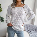 White cable-knit sweater styled with light-wash jeans, chic casual look